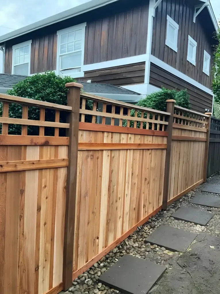 A modern wood barrier showing new full panel fence installation in Kirkland WA next to a dark house and modern path.