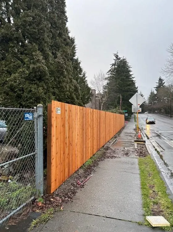 Completed cedar fence installation along a sidewalk in Kent, WA