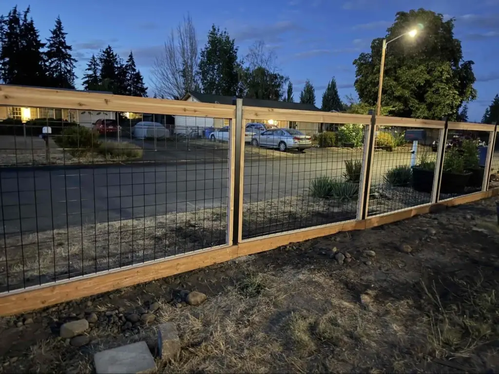 Cedar framing and black wire mesh panels installed along the front property line of a Hog Wire Fence Tacoma project.